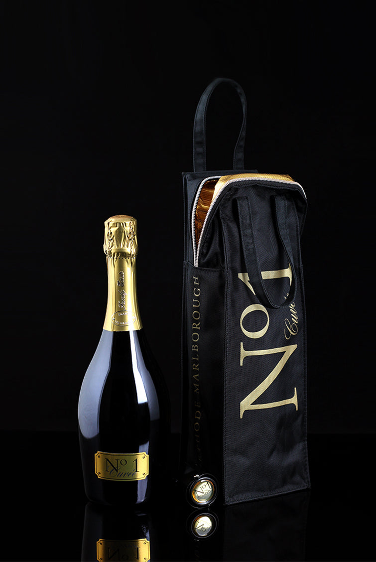 A bottle of Cuvee No.1 methode traditionelle, chiller bag and stopper on a black background
